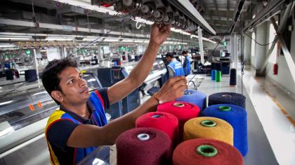 A worker in the knitting section of a garment factory in Bangladesh.