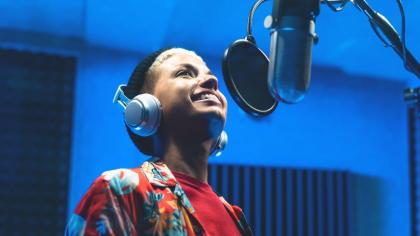 A singer records music in a studio